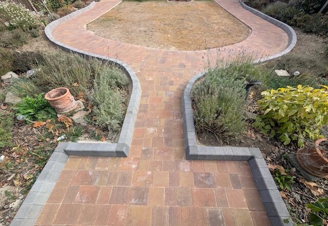 Completed curved block paving path around the Bexley garden lawn
