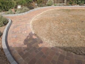 Curved block paving path beside the existing lawn in Bexley