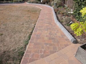 Completed block paving path along the right-hand garden border