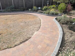 Sweeping block paving curve around the Bexley garden lawn